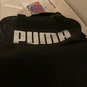 A black and silver puma bag